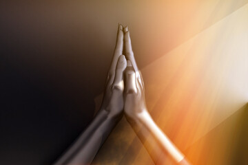 Wall Mural - two black hands in a gesture of prayer