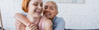 happy lesbian woman with closed eyes embracing lesbian girlfriend at home, banner
