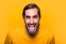 Cheerful Man Showing Tongue In Studio