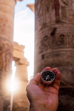 Unrecognizable Traveler With Compass In Hypostyle Hall
