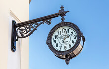 Big Decorative Street Clock Hanging On A Wall Of Building