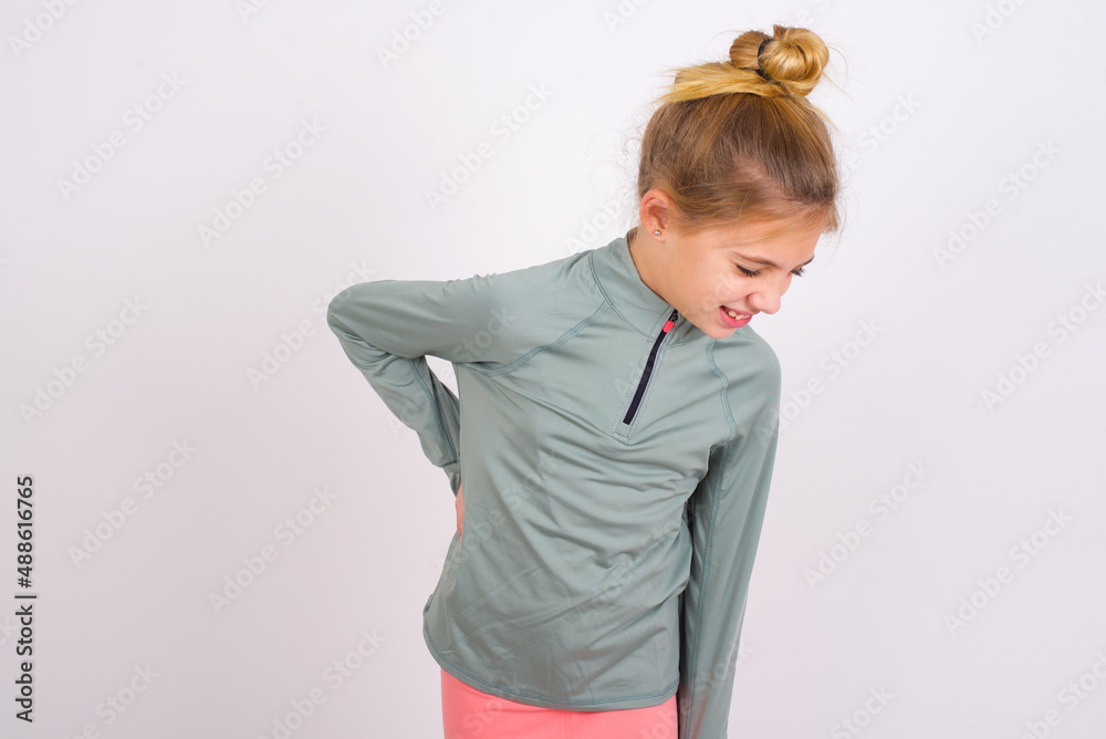 little caucasian kid girl with hair bun wearing technical shirt over ...