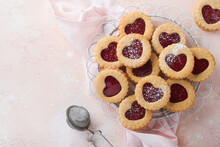 Traditional Linzer Cookie With Strawberry Jam And Powder Sugar On Pink Beautiful Background. Top View. Homemade Austrian Sweet Dessert Food On Valentines Day. Holiday Snack Concept.