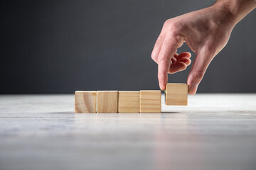 Canvas Print - Hand holding blank wooden block cubes