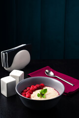 Poster - oatmeal porridge in ceramic bowl with fresh ripe berries and mint over wooden background