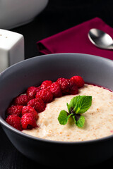 Poster - oatmeal with fresh raspberries is a healthy breakfast, oatmeal porridge in ceramic bowl with fresh ripe berries