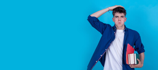 student with books isolated on blue background stressed