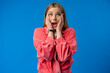 © fotofabrika - Negative nervous young woman in trouble over blue background