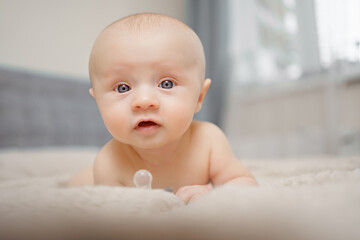 Wall Mural - Funny and beautiful baby on the bed. children's health. 