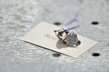 Close-up Of Silver Bells And A Thank You Tag On A Reserved Card