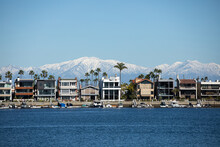 Long Beach California In Winter, View Over The Bay At Houses With Boats And Mountains With Snow, Belmont Shore