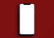 Smartphone mockup with blank white screen with red colour background and shadows.