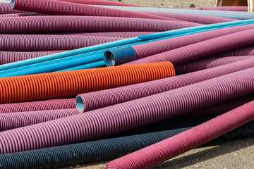 Wall Mural - Many colorful corrugated peshel pipes in the industrial area in front of the old factory