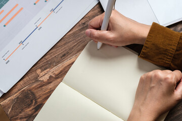 Poster - close uop woman hand writing on notebook at worknig desk at home