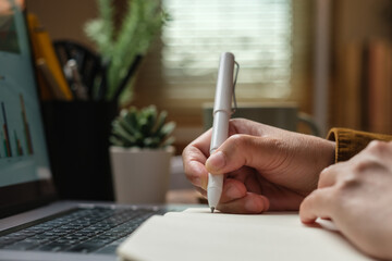 Poster - close uop woman hand writing on notebook at worknig desk at home