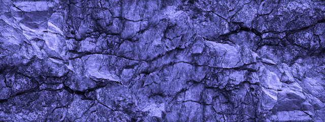 Wall Mural - light purple blue rock background. wide banner. toned cracked mountains surface texture. close-up. s