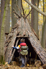 Little Boy Scout During Hiking In Autumn Forest. Child Examining Teepee Hut In Woodland. Concepts Of Adventure, Scouting And Hiking Tourism For Kids.