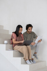 Aufkleber - Happy young businessman with financial document sitting by female colleague with laptop making presentation of online data