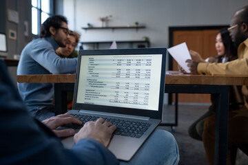 Aufkleber - Hands of mature businessman tying on laptop keyboard while preparing financial report or presentation for young coworkers