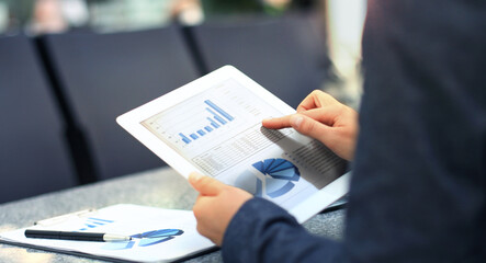 Businessman using digital tablet computer with modern mobile phone.