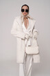 Beautiful young lady in a white faux fur coat