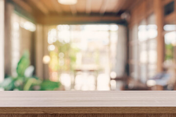 Wooden table top with blurred people in coffee shop and cafe background for display montage, copy space.