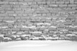 Brick wall and snow in black and white