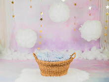 A Basket For A Newborn Baby With Clouds And Stars In The Background