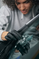 Canvas Print - Car detailing professional removing glass debris from crack site