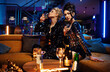 © konradbak - Two young attractive ladies having fun at the party