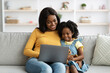 © Prostock-studio - Digital Leisure. Happy Black Mother And Little Daughter Using Laptop At Home