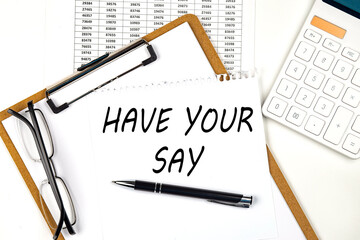 Fototapete - Text HAVE YOUR SAY on the white paper on clipboard with chart and calculator