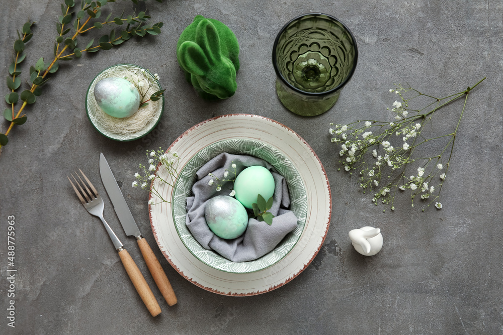 Stylish table setting for Easter celebration with gypsophila flowers on grey background