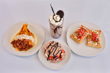 Sticker - A closeup shot of the burritos, beef taco plate, chocolate milkshake and strawberry dessert on the white background