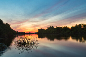 Wall Mural - red bloody sunset over the river in summer