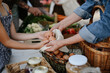 © Halfpoint - Close up of little girl buying organic eggs outdoors at local farmers market.
