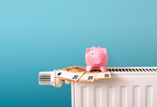 Save Money, Energy And Heating Costs, Piggy Bank On Radiator And Euro Money Notes