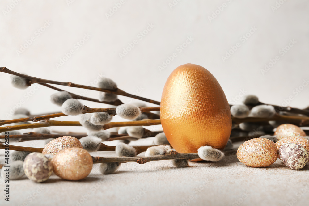 Painted Easter eggs and pussy willow branches on light background