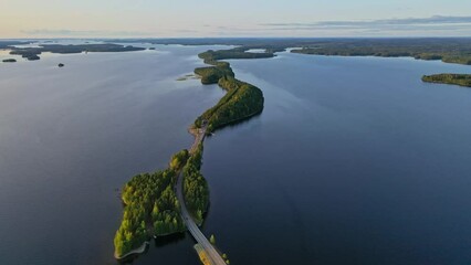 Wall Mural - Aerial view of of islands on a blue lake Paijanne. Blue lake, islands and green forest from above on a sunny summer evening. Lake landscape in Finland