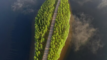 Canvas Print - Aerial view of the road between the islands of blue lake Paijanne. Blue lake, islands and green forest from above on a sunny summer evening. Lake landscape in Finland