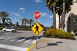 A stop sign with a Pedestrian Crossing Sign outside a shopping mall is shown in Orlando, Florida, USA. 