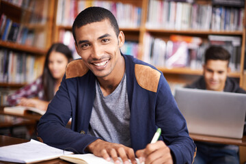 Aufkleber - Hes such a diligent student. Cropped portrait of a handsome young student working diligently in his classroom.