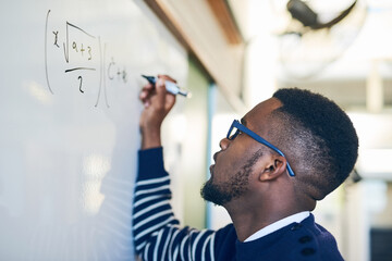 Poster - Just try until you get it right. Cropped shot of a young man writing on a whiteboard in a classroom.