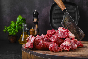 Wall Mural - Chopping fresh beef meat on wooden chopping stump