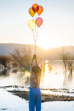 Anonymous Woman With Balloons Against Clear Sky