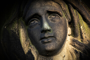 Fototapete - Fragment of an ancient statue of Virgin Mary. Vintage sculpture of sad woman in grief (Religion, faith, suffering, love concept)