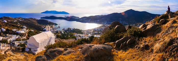 Wall Mural - Breathtaking panoramic sunset view of Ios island. Chora town with churches and whitwashed houses. Popular tourist destination in Cyclades, Greece