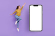 Full length profile photo of excited lady raise fist hurry cellphone poster buy isolated purple color background