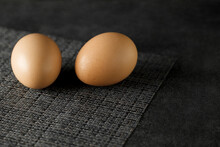 Two Whole Eggs On Gray Napkin And Dark Background, Selective Focus.