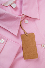 Wall Mural - price tag hang over pink shirt close up view - Image